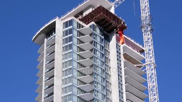 Motion of construction of new high-rise building in city — Stock Video