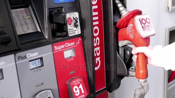 Moción de la mujer que se prepara para llenar el gas en la gasolinera Petro Canada — Vídeo de stock