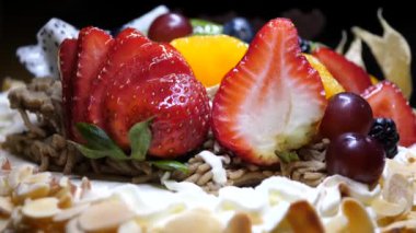 Meyve doğum günü pastası siyah bir arka plan üzerinde hareket
