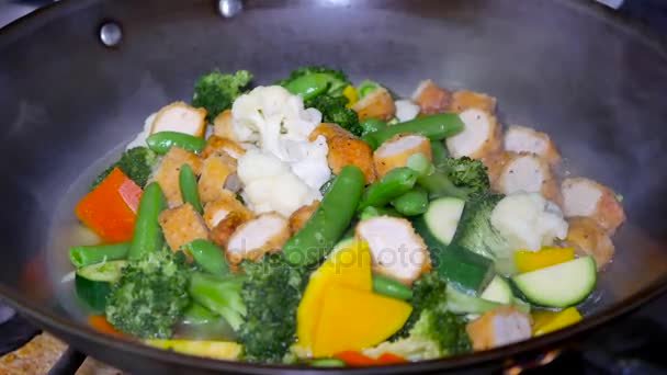 Motion of cooked vegetable with steam in a pan — Stock Video