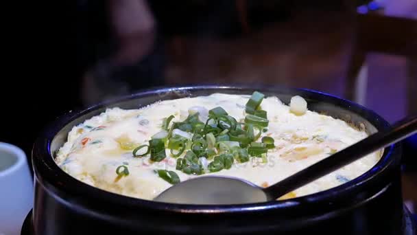 Motion of woman taking steamed egg on table inside Korean restaurant — Stock Video