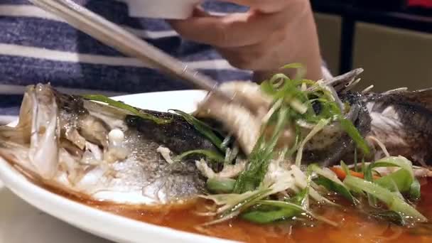 Motion Woman Eating Steamed Bass Herbs Vegetable White Dish Serve — Stock Video