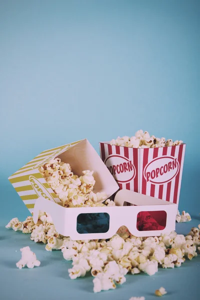 Popcorn bucket against a blue background Vintage Retro Filter.