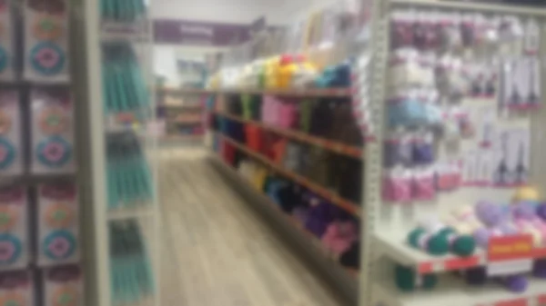 Stacked shelves inside a craft shop. Out of focus. — Stock Photo, Image