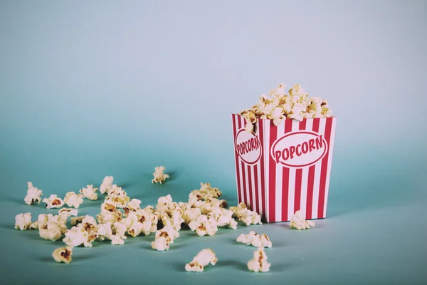 Plechovka popcorn na modrém pozadí Vintage Retro filtru. — Stock fotografie