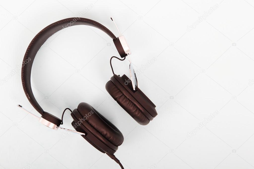 Black headphones against a light coloured background