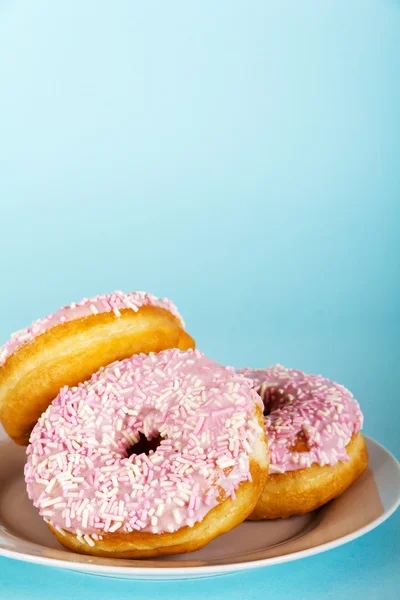 Iced doughnut on a light blue background — Stock Photo, Image
