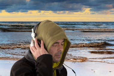 Kulaklık dinleme kapüşonlu adam