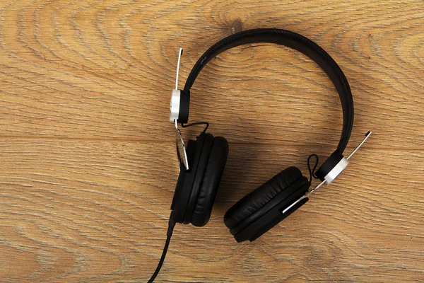 Pair of headphones on a rustic wooden surface — Stock Photo, Image