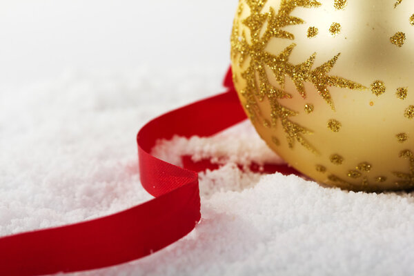 Gold Christmas decorations in white snow for background