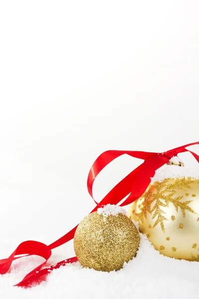 Gold Christmas decorations in white snow for background — Stock Photo, Image