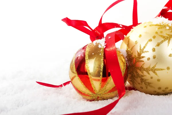 Gold Christmas decorations in white snow for background Stock Image