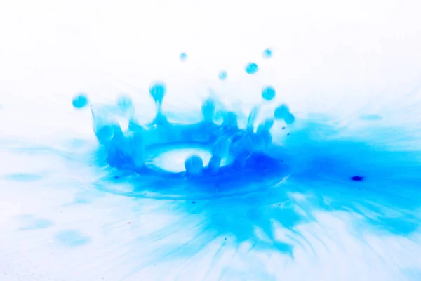 Paint drop splashing on black a background — Stock Photo, Image