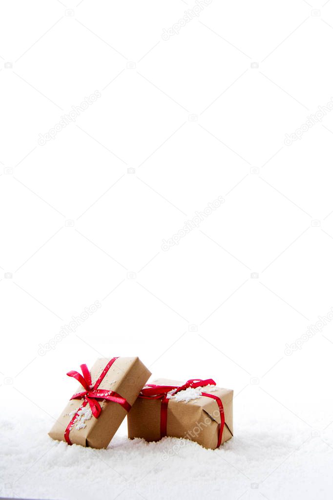 Christmas presents in brown paper with red ribbon