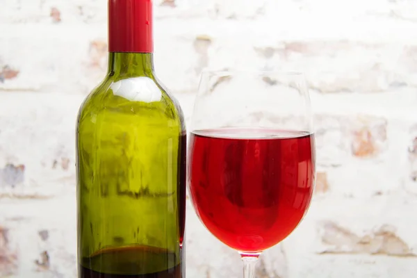Bottle of red wine with glass ready to pour — Stock Photo, Image