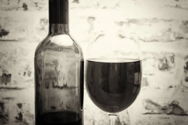 Bottle of red wine with glass ready to pour — Stock Photo, Image