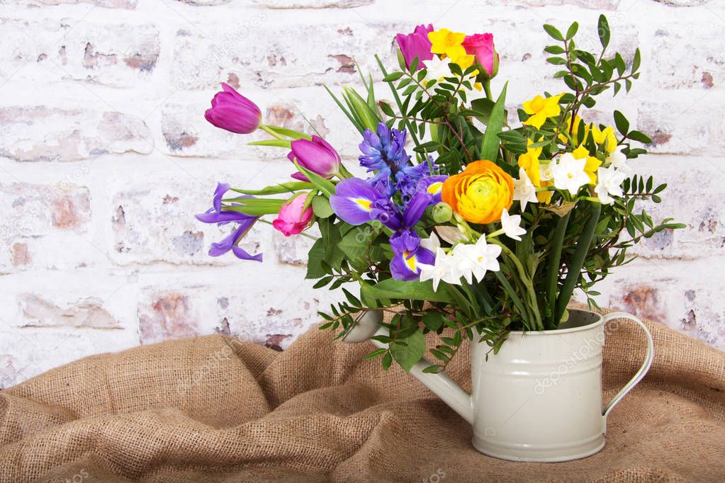 Spring flower arrangement against a rustic background