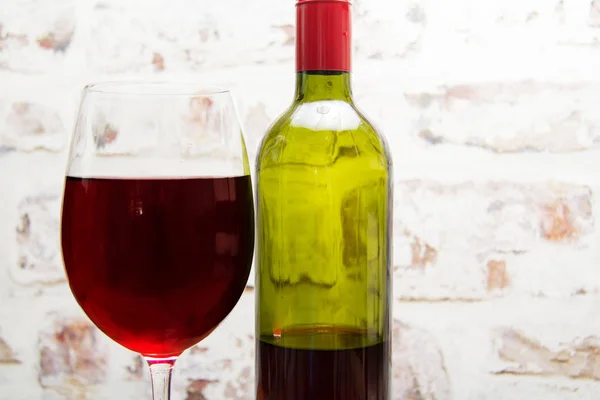 Bottle of red wine with glass ready to pour — Stock Photo, Image