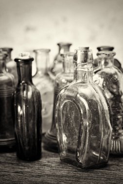 Rustik bir arka plan üzerinde renkli cam şişe