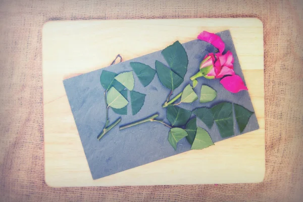 Rose cut up on piece of slate