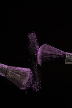 Mor toz siyah arka plan üzerine fırçayla makyaj