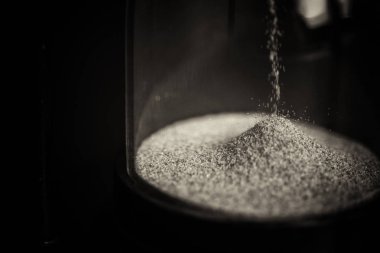 Büyük siyah siyah bir arka plan karşı kum saati