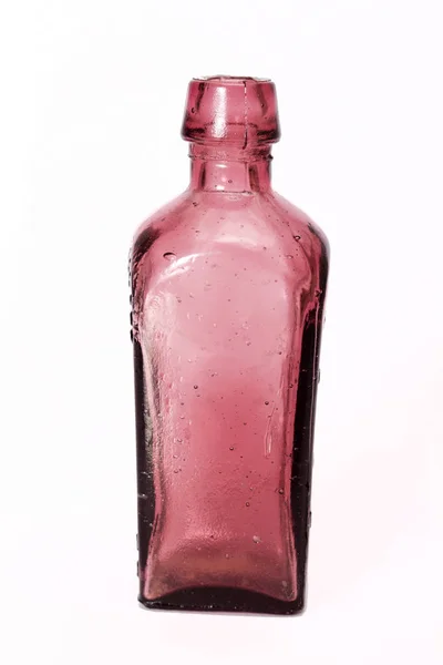 Oude kleurrijke flessen tegen een witte achtergrond — Stockfoto