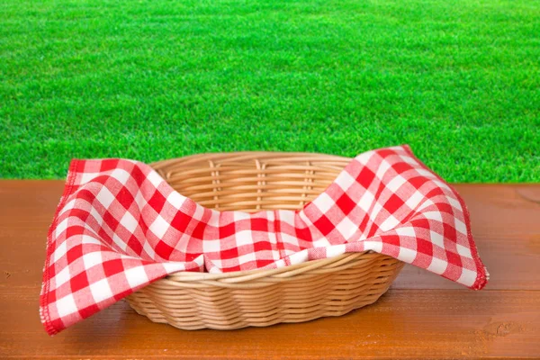 Wicker Basket Red Napkin Wooden Table Back Grass Background — Stock Photo, Image