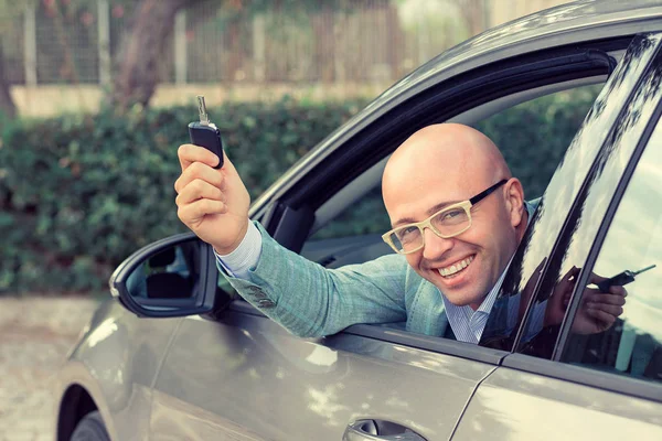 Hombre de negocios guapo mirando atrás por la ventana sosteniendo ca — Foto de Stock