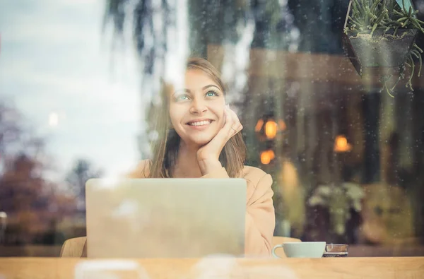 Daydreaming. Pensive beautiful woman with coffee mug sitting nex — Stock Photo, Image