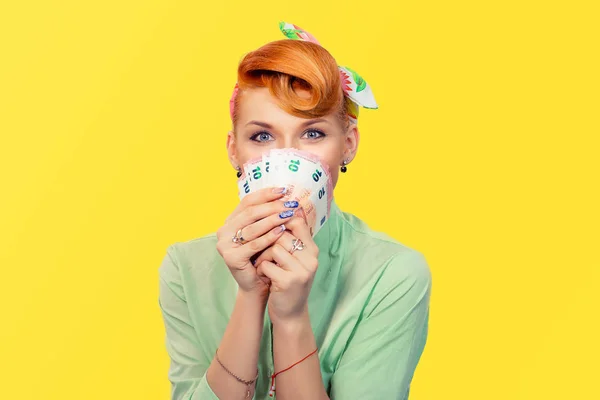 Lottery win Closeup portrait super happy excited successful young business woman holding money euro bills in hand isolated yellow background Positive emotion facial expression feeling Financial reward