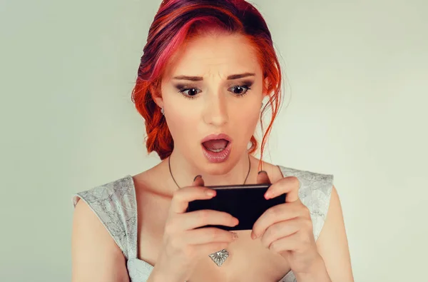 Shocked woman looking at phone