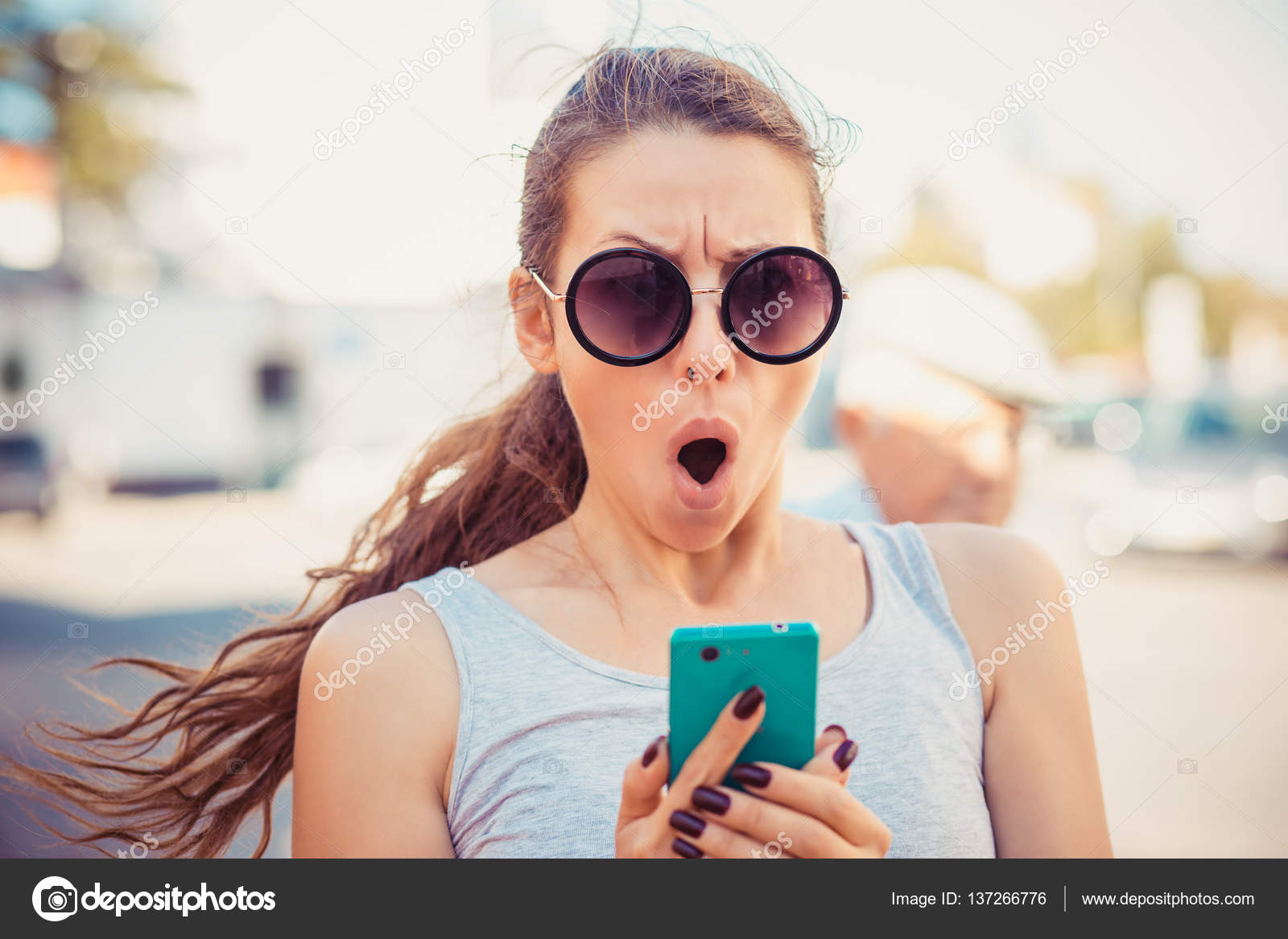Scared young girl looking at phone Stock Photo by ©HBRH 137266776