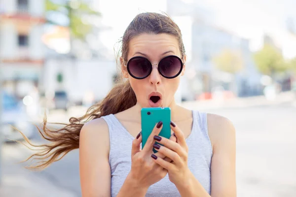 Shocked anxious scared young girl looking at phone seeing bad news — Stock Photo, Image