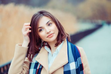 Young girl in coat thinking looking away. clipart