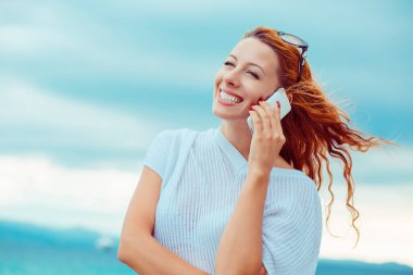 Genç mutlu kadın okyanus deniz arka plan, Sardunya İtalya ile bir plajda cep telefonunda söz 