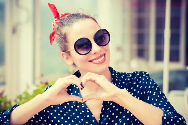 Love you. woman showing heart sign gesture with hands