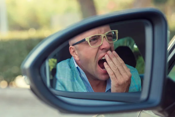 Side mirror view reflection sleepy tired fatigued yawning exhaus — Stock Photo, Image