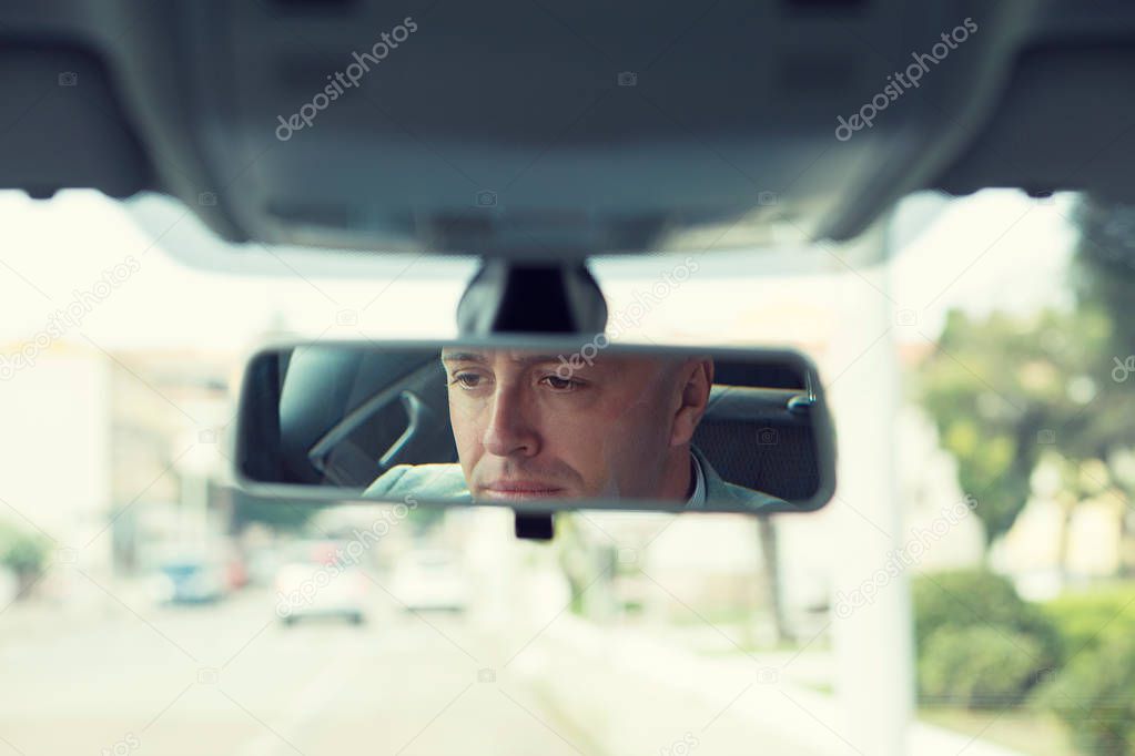 man driver reflection in rear view mirror isolated interior car windshield background