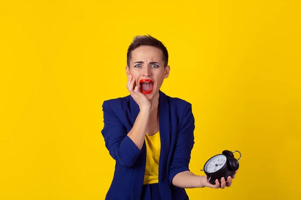 Woman running late. Closeup portrait young pretty beautiful business woman frustrated by lack of time to perform all duties for the day isolated yellow background. Negative emotion facial expression f — Stock Photo, Image