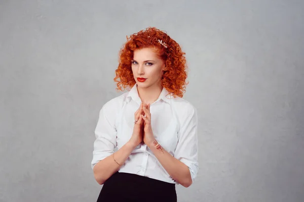Plotting. Closeup portrait sneaky, sly, scheming young redhead woman plotting revenge plan, prankster isolated on gray wall background. Negative human emotion facial expression feelings body language — Stock Photo, Image