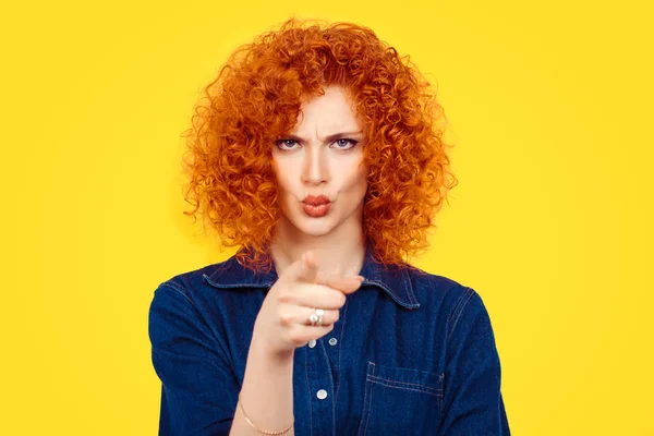 It's you! Portrait angry annoyed redhead curly hair woman getting mad pointing finger at you camera showing hand gesture this is you, you chosen, isolated on yellow wall background.  Negative emotions — Stock Photo, Image