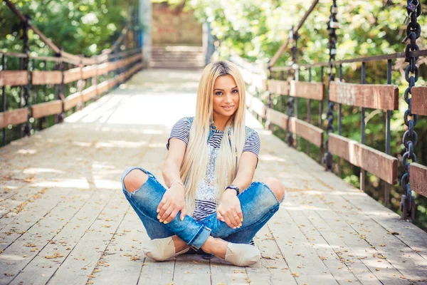 Stijlvolle blonde poseren op brug — Stockfoto