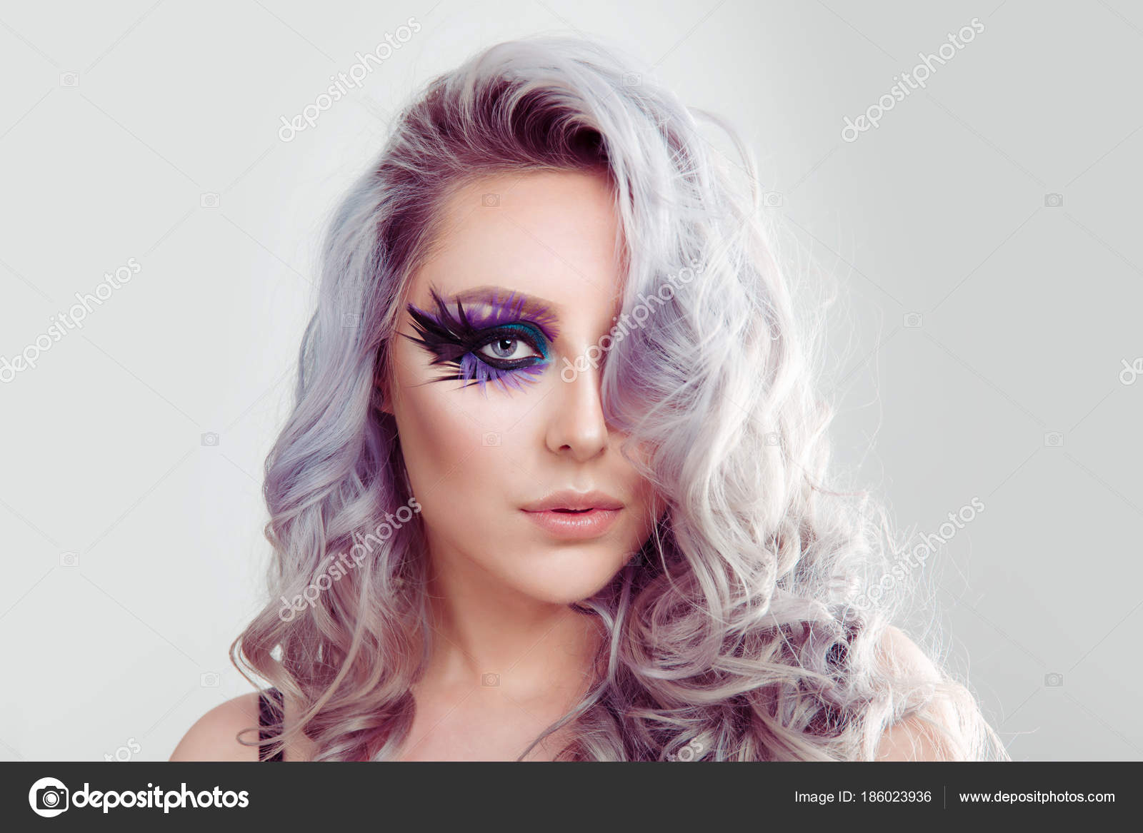 Beautiful Woman With Artistic Purple Blue Eyes Makeup Feather On