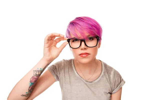 Mulher com cabelo rosa magenta e olhos verdes franzindo as sobrancelhas segurando óculos — Fotografia de Stock