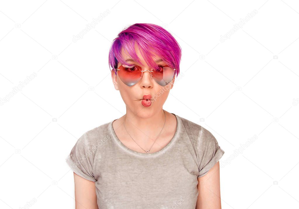 Woman making a fish-face, puckering lips wearing heart shape pink sunglasses