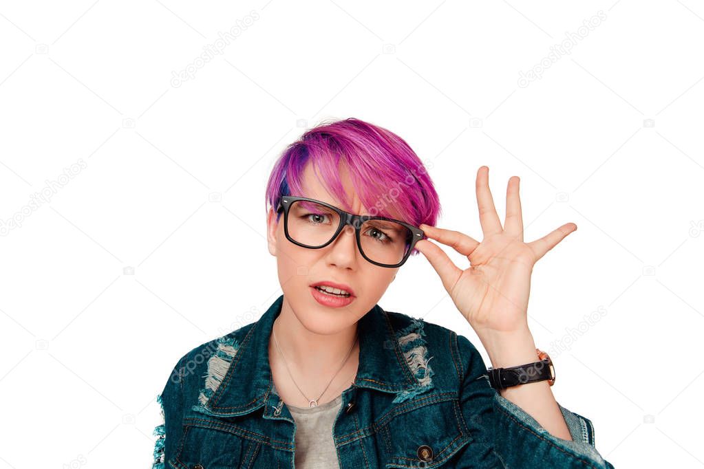woman dressed casually in denim stares through glasses, skeptically looking at you