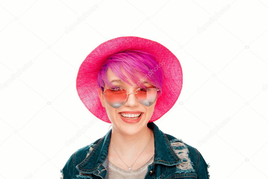 Happy woman magenta short hairs pink hat on head red blue heart shaped sunglasses