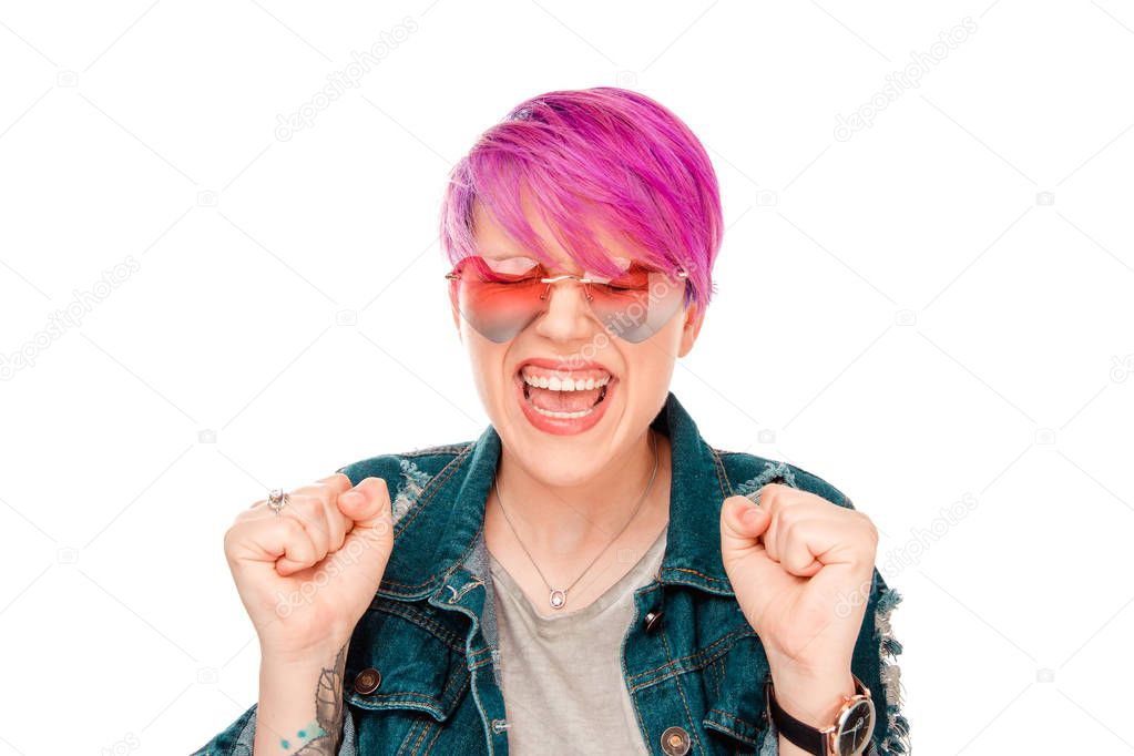 young woman happy exults pumping fists ecstatic isolated white wall