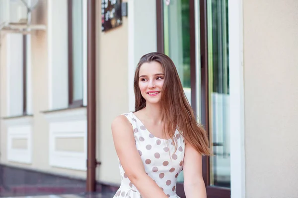 Retrato de cerca de una joven sonriendo y mirando a un lado sentado en las escaleras — Foto de Stock